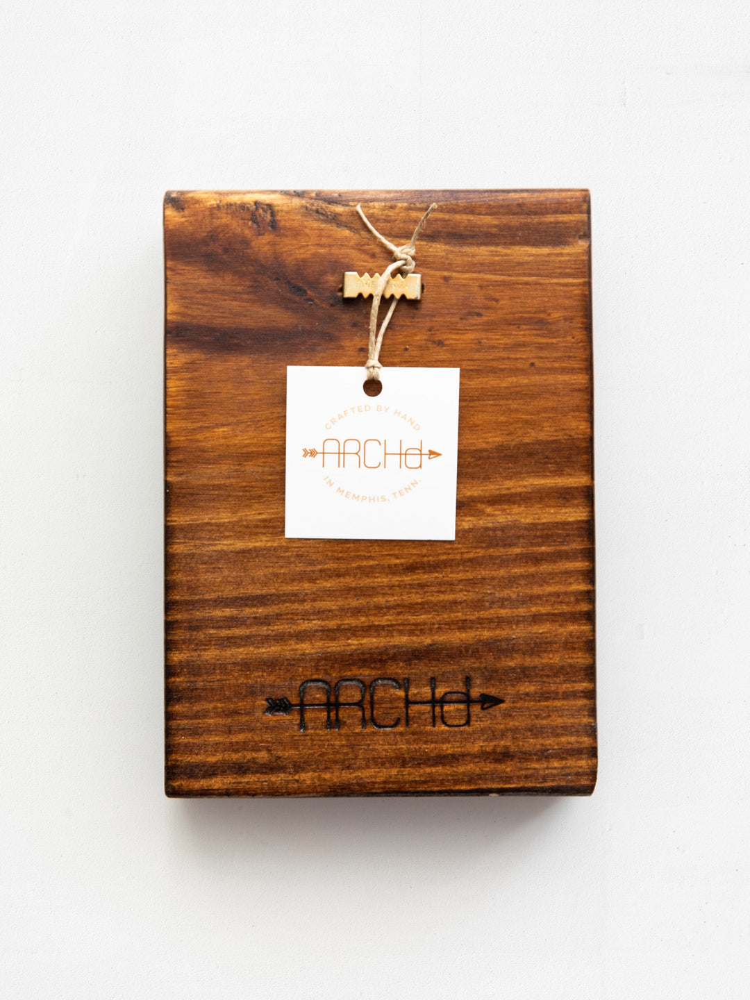 back view of wood art packaging with a tag and sawtooth backer for hanging