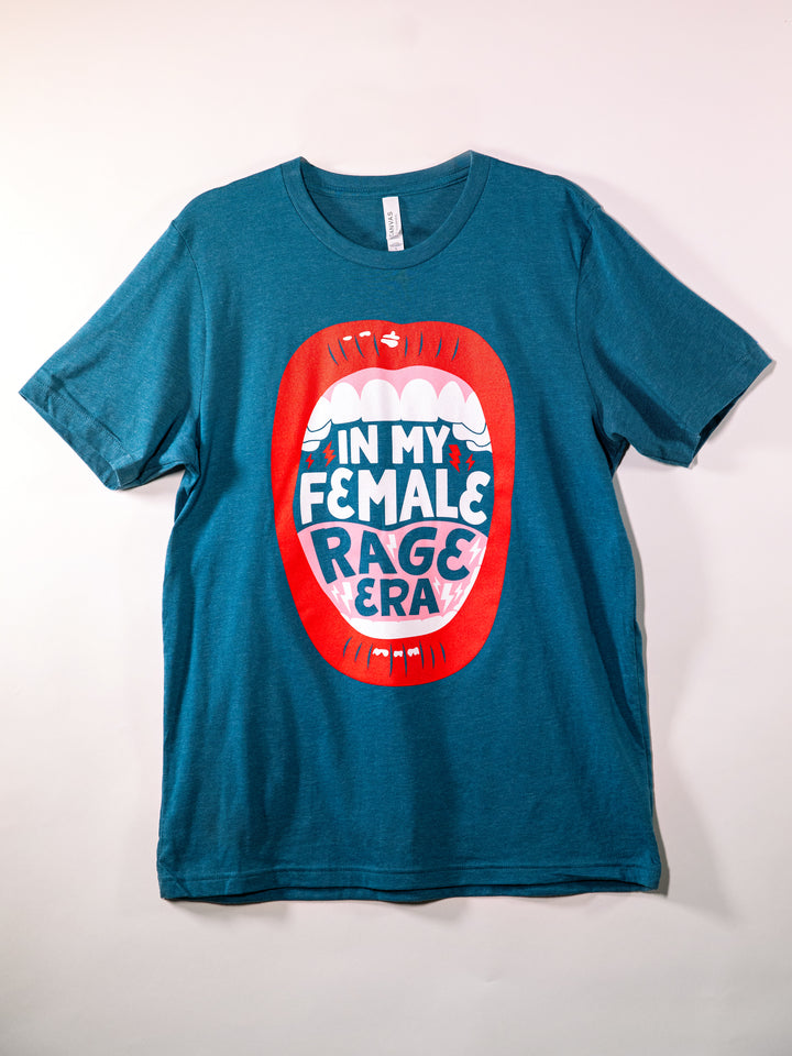 teal crew neck t-shirt with lips, open mouth red lips illustration and saying, "In my female rage era." flat, on white background