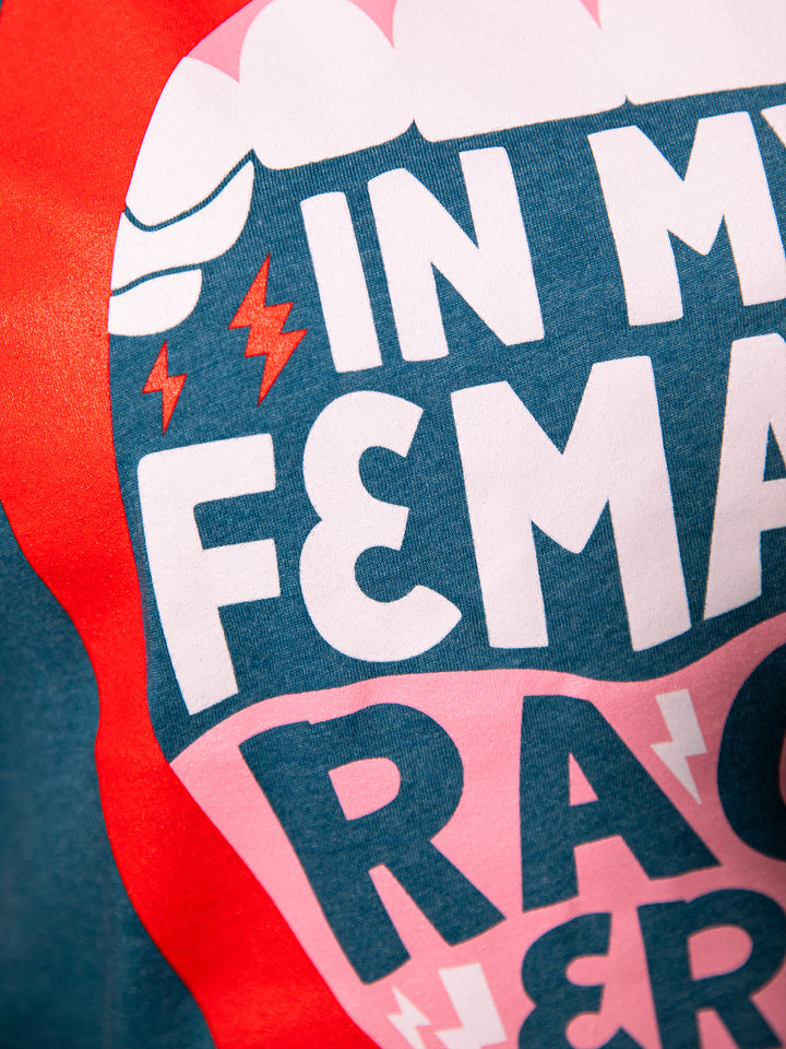 close up view of screen-printed graphic  with lips, open mouth red lips illustration and saying, "In my female rage era." on teal crew neck unisex t-shirt