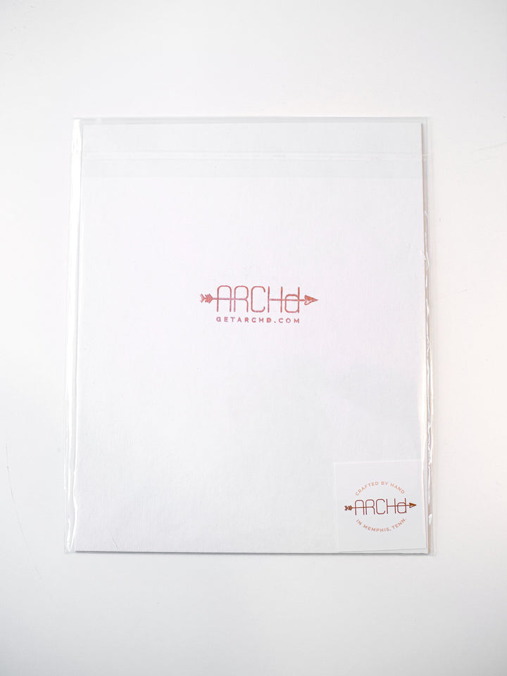 Back view of art print packaging in clear bag with rigid backer board to help print stay flat during mailing.