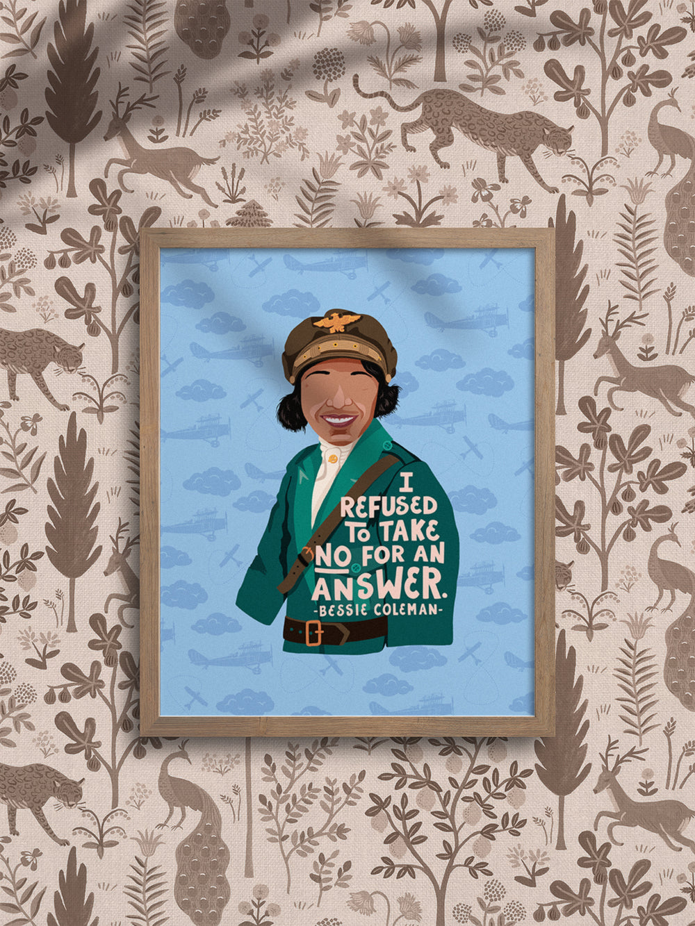 Bessie Coleman I refused to take no for an answer quote and illustration 8x10 wall art hanging in an oak frame on a wallpapered wall. Bessie Coleman art