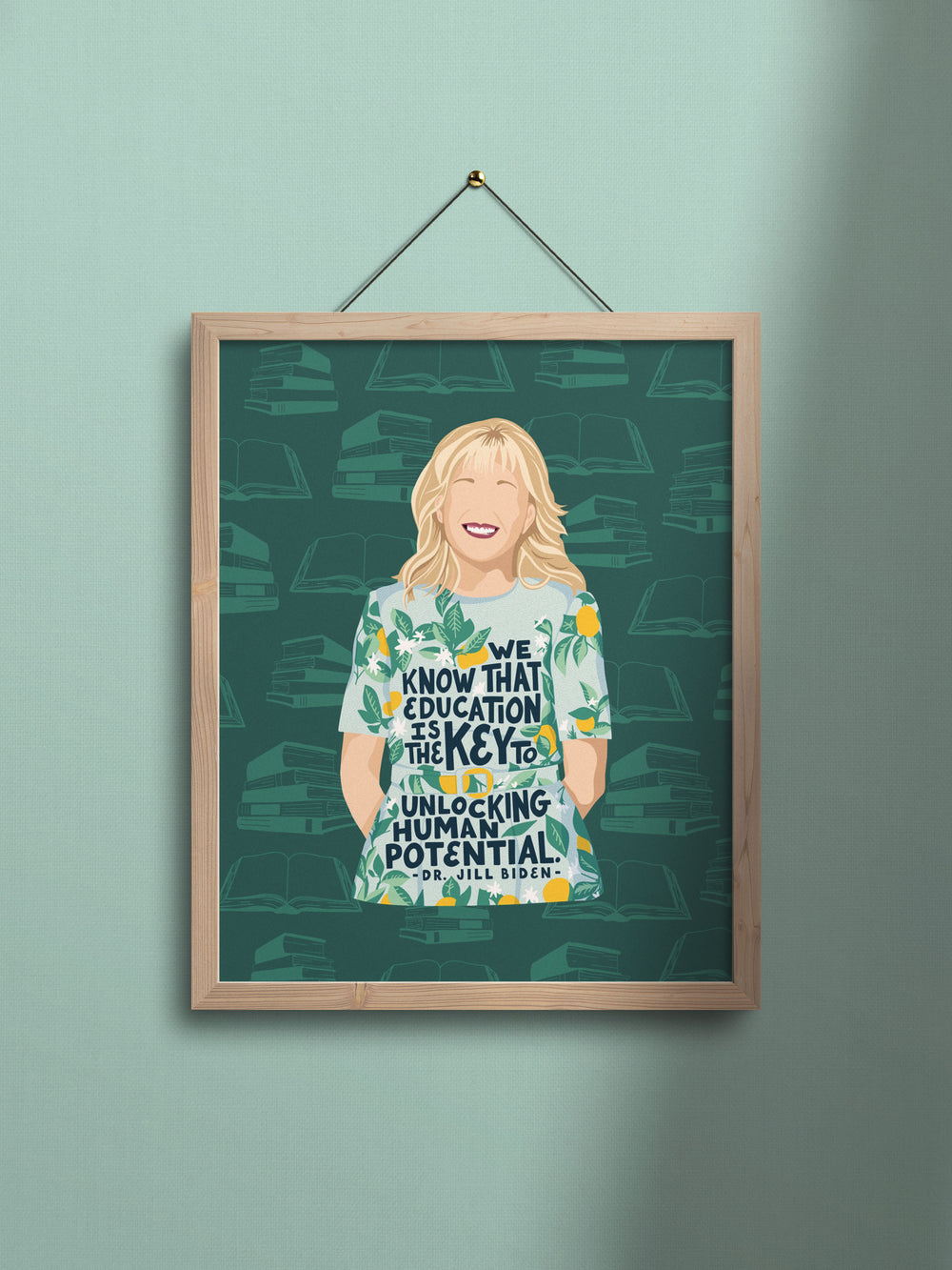 Dr. Jill Biden art print in light wood frame hanging on light green wall. Jill biden quote