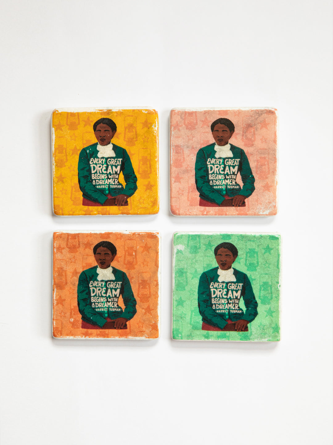 Set of 4 marble coasters on white background. Each coaster depicts the same illustration of Harriet Tubman each with a different colored background. Yellow, pink, orange, and green. harriet tubman art