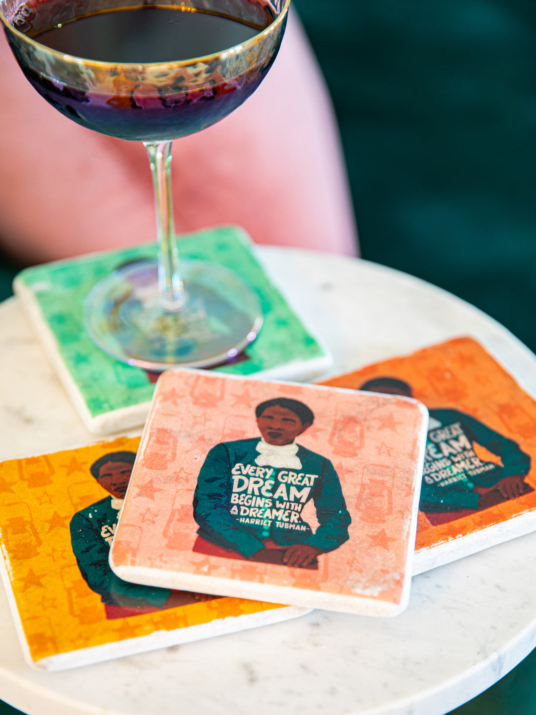 Close up of the Harriet Tubman coaster with pink background on table top. harriet tubman art