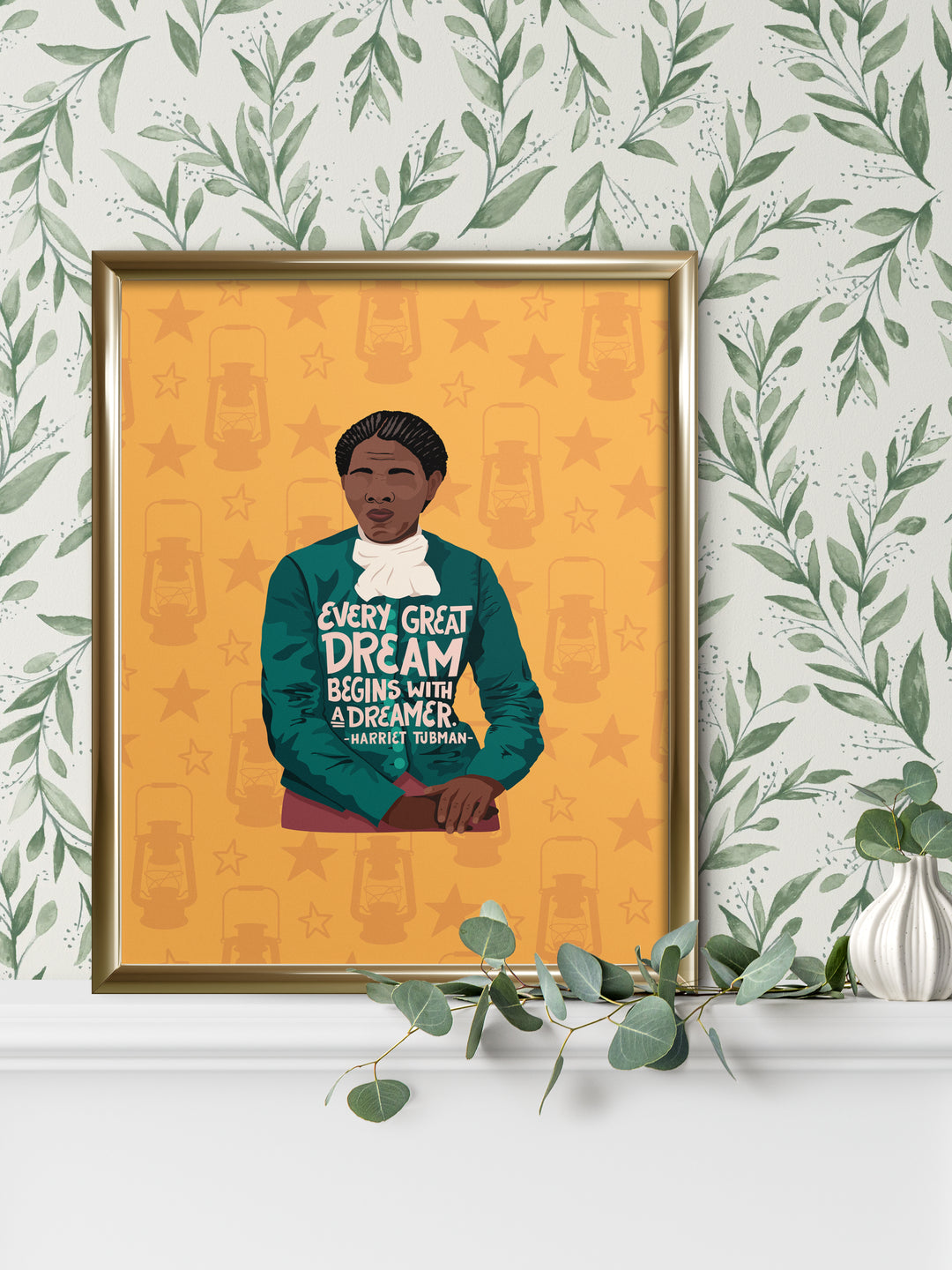 Large poster print of Harriet Tubman illustration. Framed and sitting on a mantle with foliage wallpaper behind it. harriet tubman art