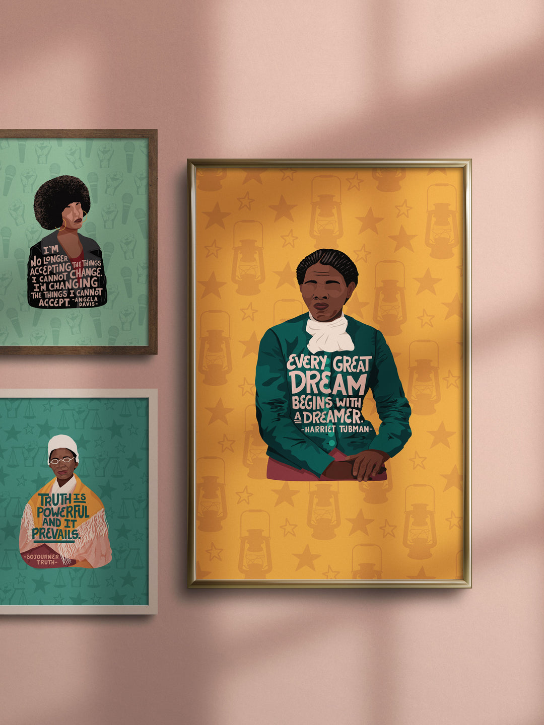Large poster print of harriet tubman illustration framed and hung on a pink wall next to, two other illustration of angela davis and sojourner truth. harriet tubman art