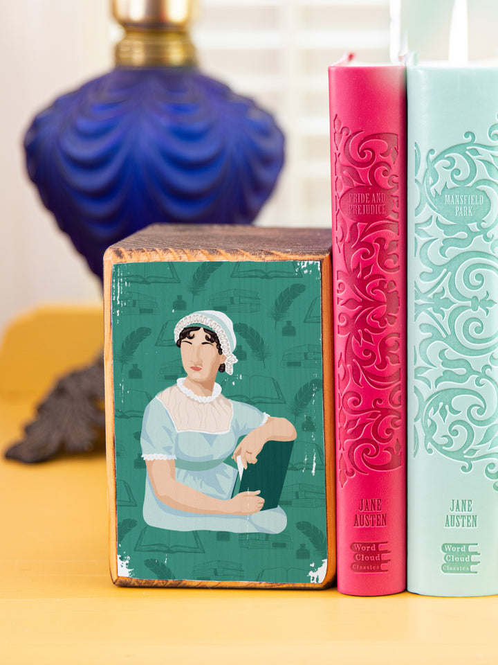 close up of Jane Austen bookend on a gold side table holding up two books. Jane Austen gifts