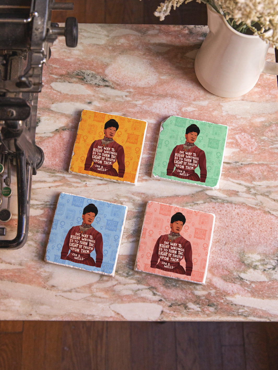 Original illustration of Ida B. Wells with her quote, "The way to right wrongs is to turn the light of truth upon them." marble coaster set of 4 on a marble table beside a typewriter and vase of flowers. ida b wells art