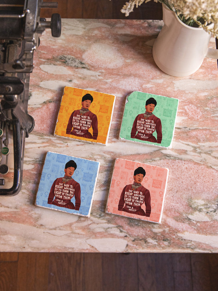 Original illustration of Ida B. Wells with her quote, "The way to right wrongs is to turn the light of truth upon them." marble coaster set of 4 on a marble table beside a typewriter and vase of flowers. ida b wells art