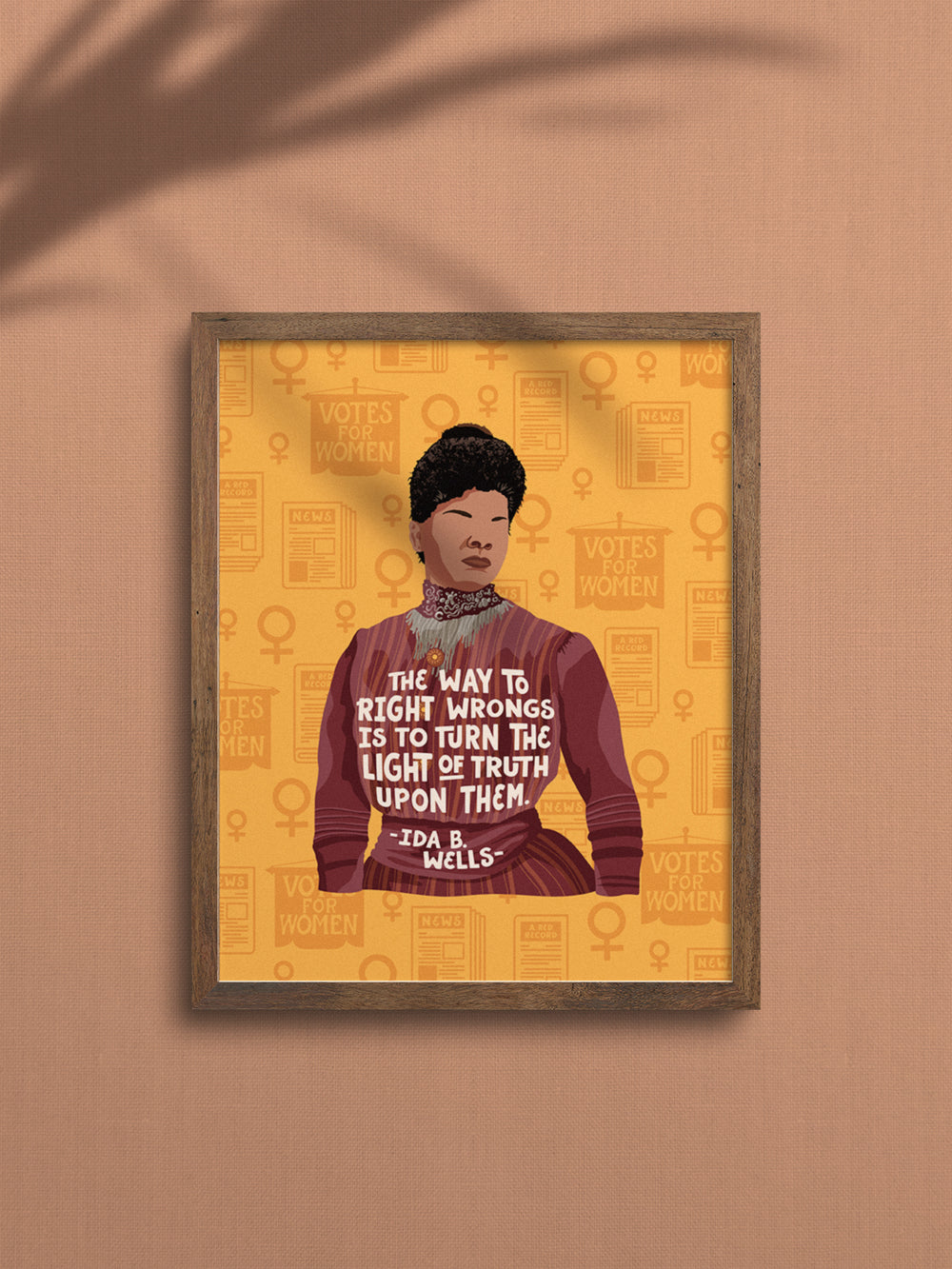 Original illustration of Ida B. Wells with her quote, "The way to right wrongs is to turn the light of truth upon them." wall art framed in an oak frame on a mauve wall. ida b wells art