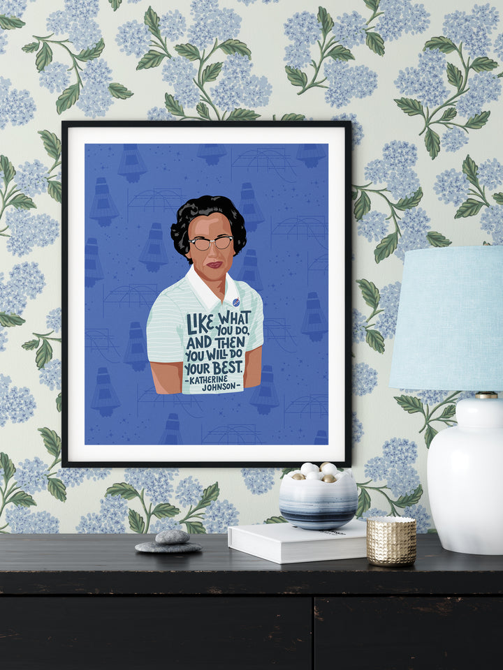 Katherine Johnson large poster print. Framed, matted and hung on a floral wallpapered wall above a dresser. Katherine Johnson art
