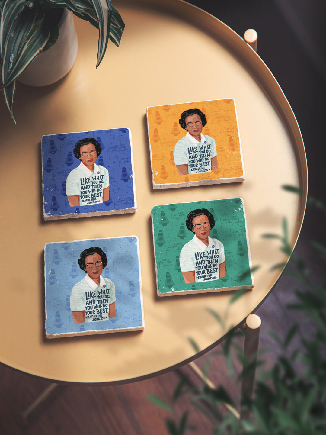 Life style photo of katherine johnson set. 4 coasters sitting on gold side table. Katherine Johnson art