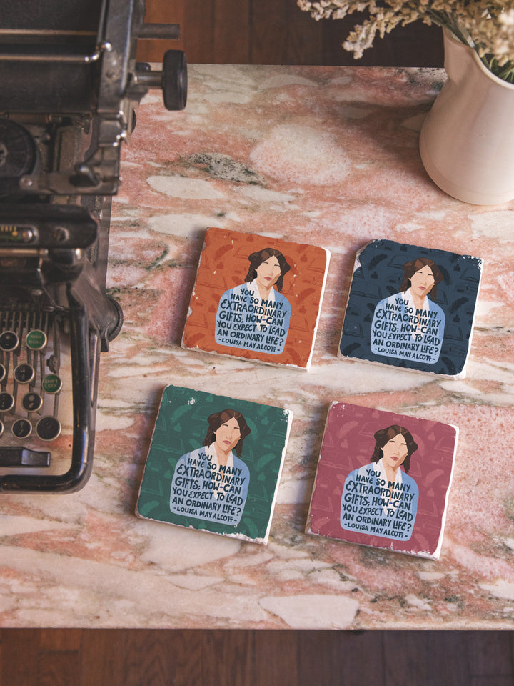 Louisa May Alcott marble coaster set of 4 on marble table beside typewriter. Louisa May Alcott gifts