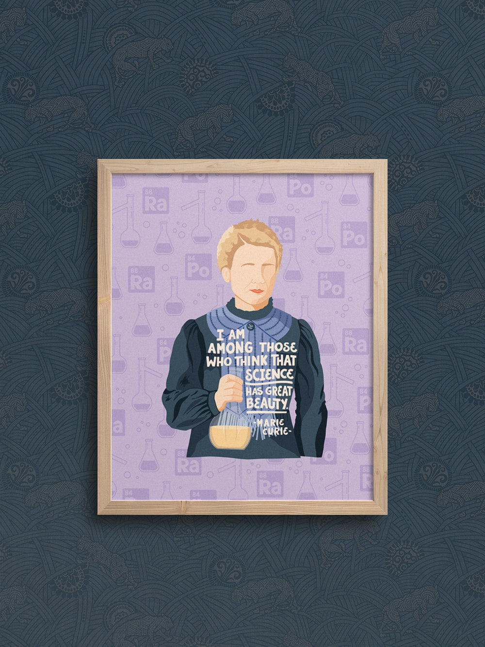 illustration of Marie Curie with her quote, "I am among those who think that science has great beauty." in oak frame hanging on navy blue wallpapered wall. Marie Curie art
