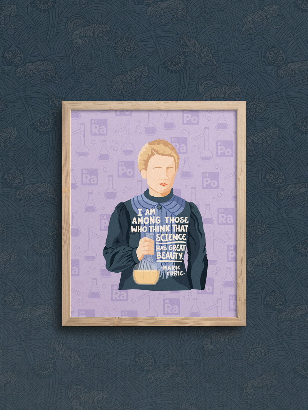 illustration of Marie Curie with her quote, "I am among those who think that science has great beauty." in oak frame hanging on navy blue wallpapered wall. Marie Curie art