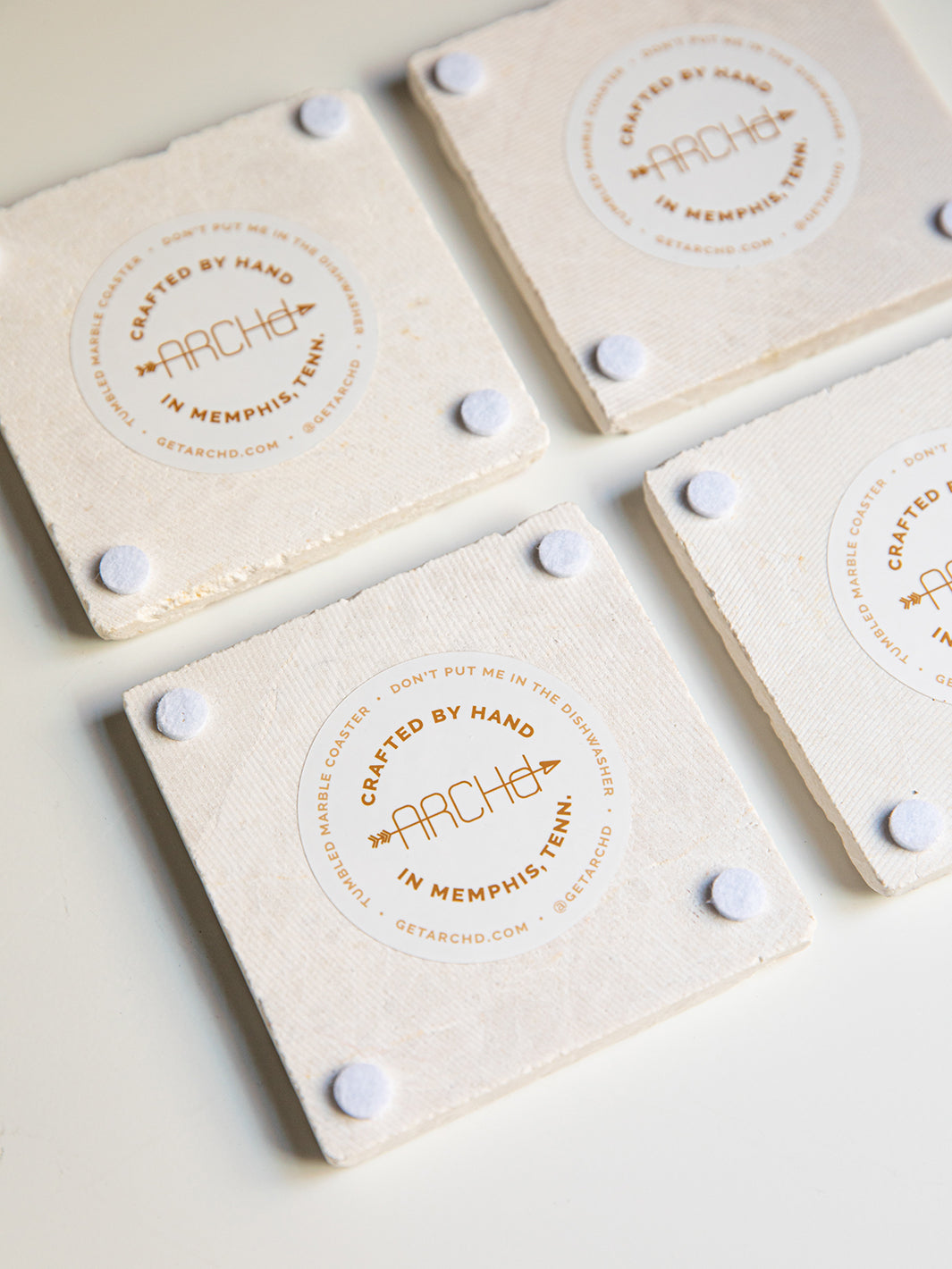 Back view of ARCHd marble coaster sets with logo sticker