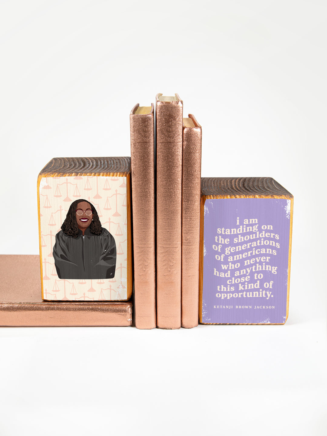 Judge Ketanji Brown Jackson bookend set on a white background holding copper books. Ketanji Brown Jackson art