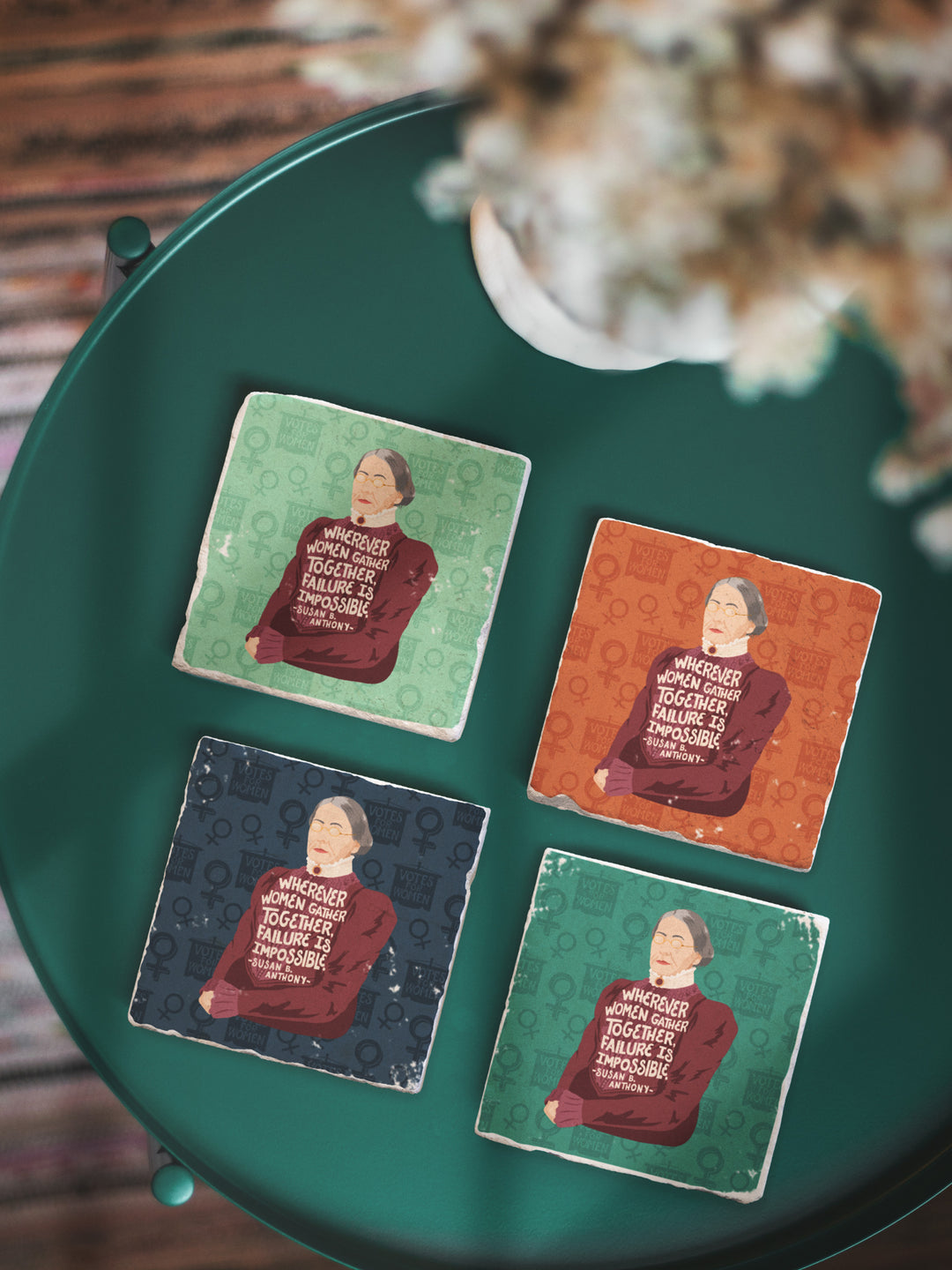 Set of 4 marble coasters of Susan B. Anthony on a round green table with a plant above. Susan B Anthony art