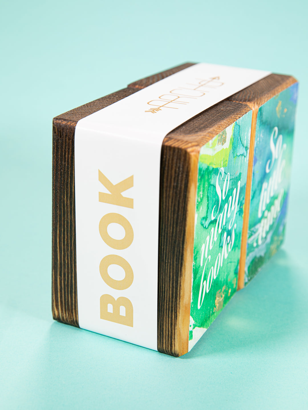 side view of bookend set wrapped in white paper sleeve