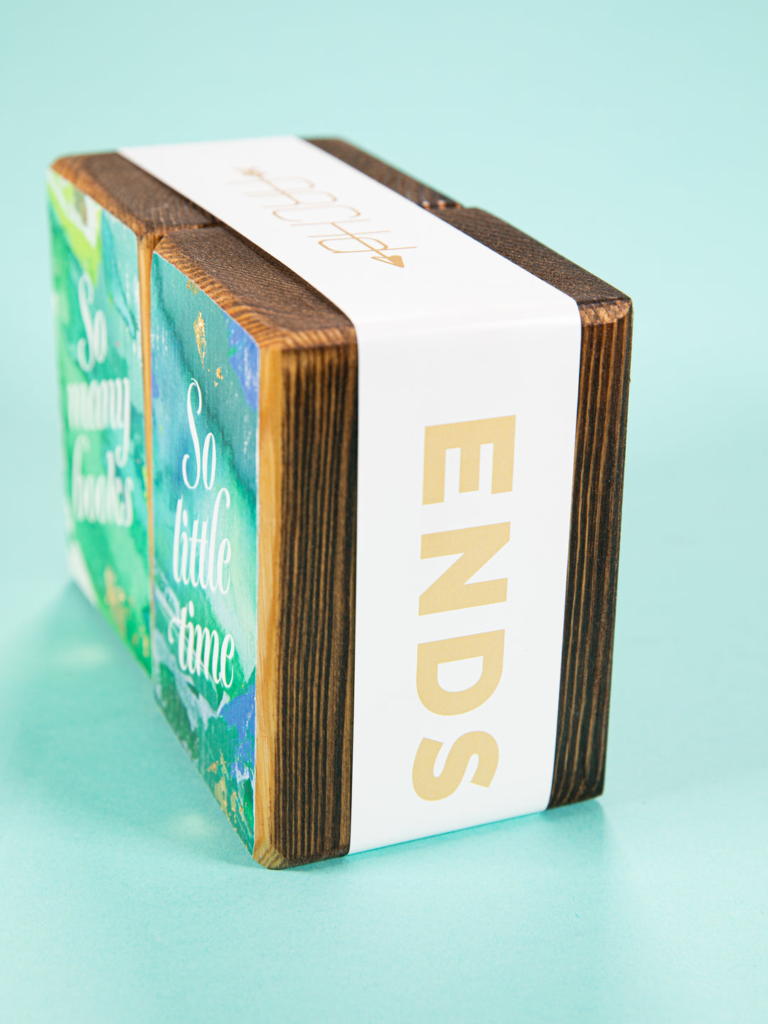 side view of bookend set wrapped in white paper sleeve