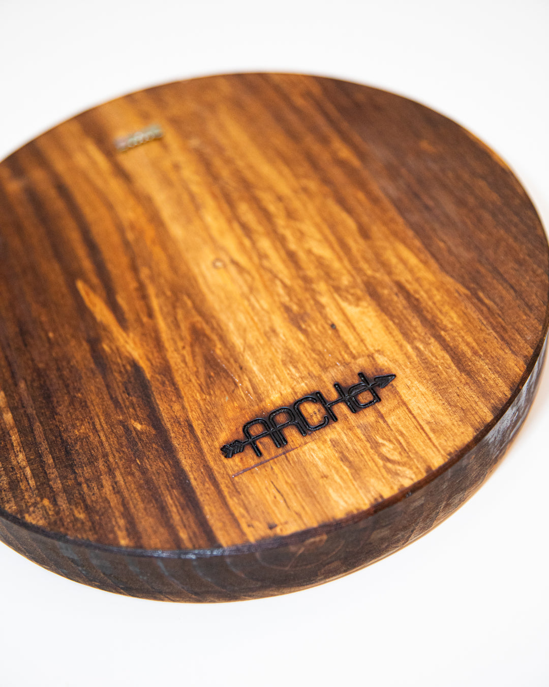 Wood round back view with ARCHd brand and sawtooth backer for hanging